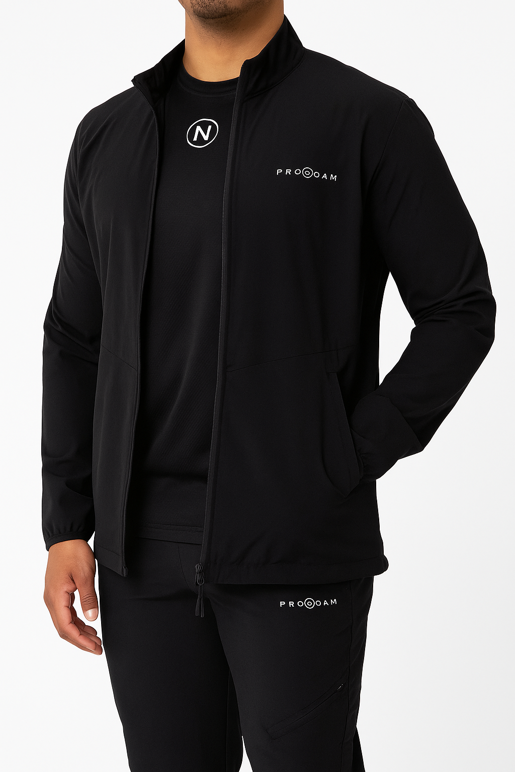 PRONOAM black tapered sports trousers with "N" logo and side zip pockets.
